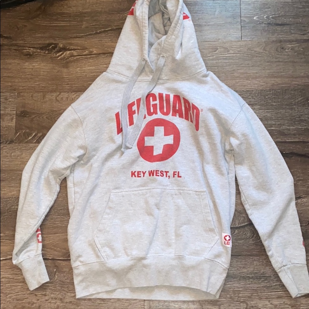 A gray and red lifeguard sweatshirt